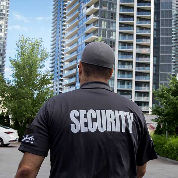 basic_sec security guard standing in front of a building